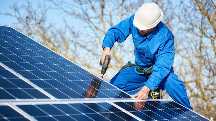 Technician installing solar panels